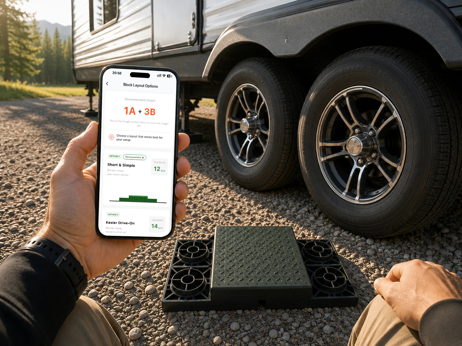 Phone showing leveling guidance beside an RV wheel