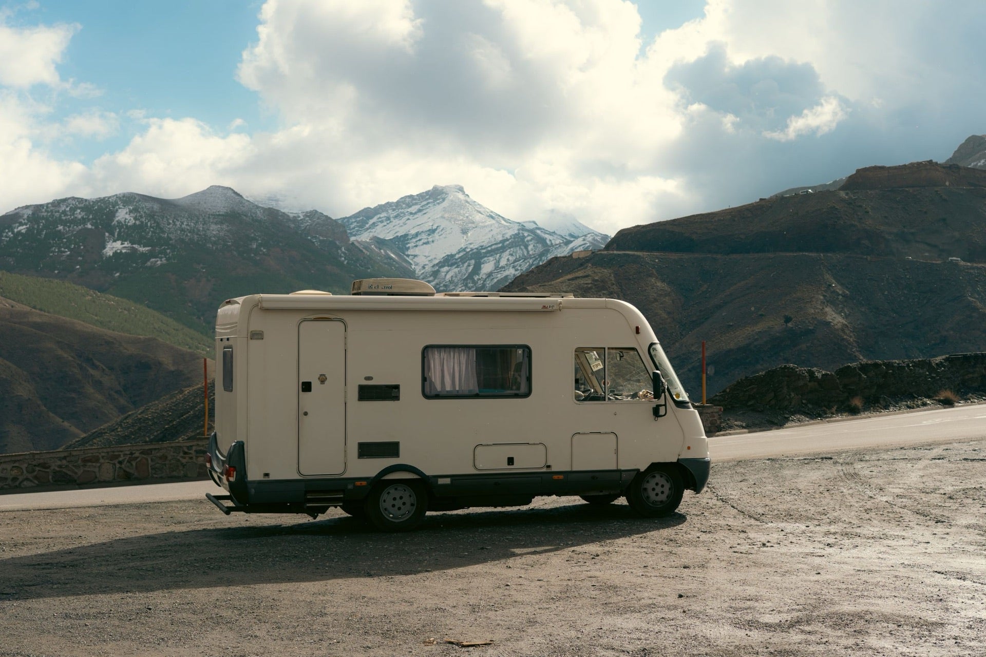 An RV journey through a wide mountain landscape