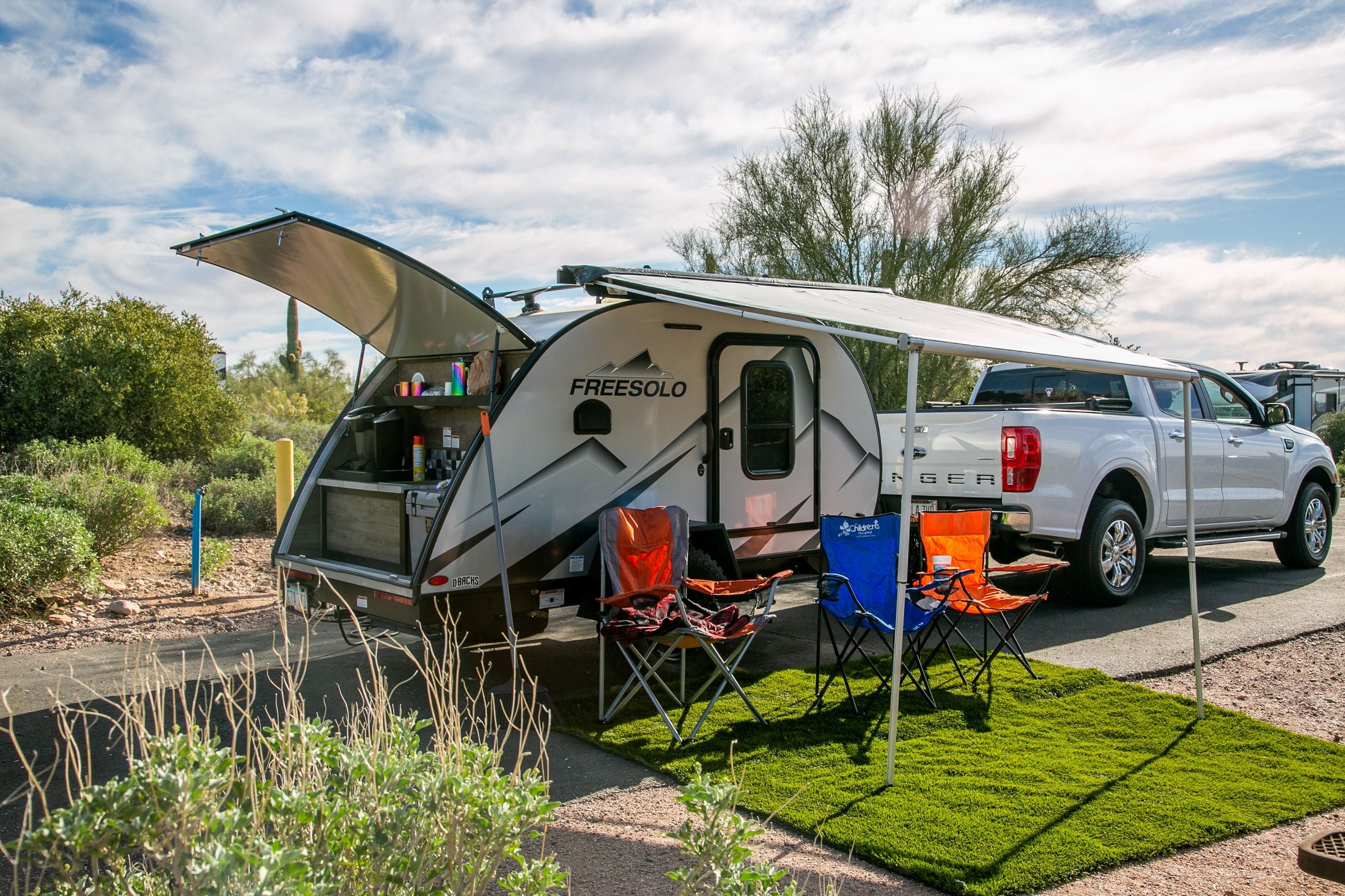 Travel trailer set up at a real campsite