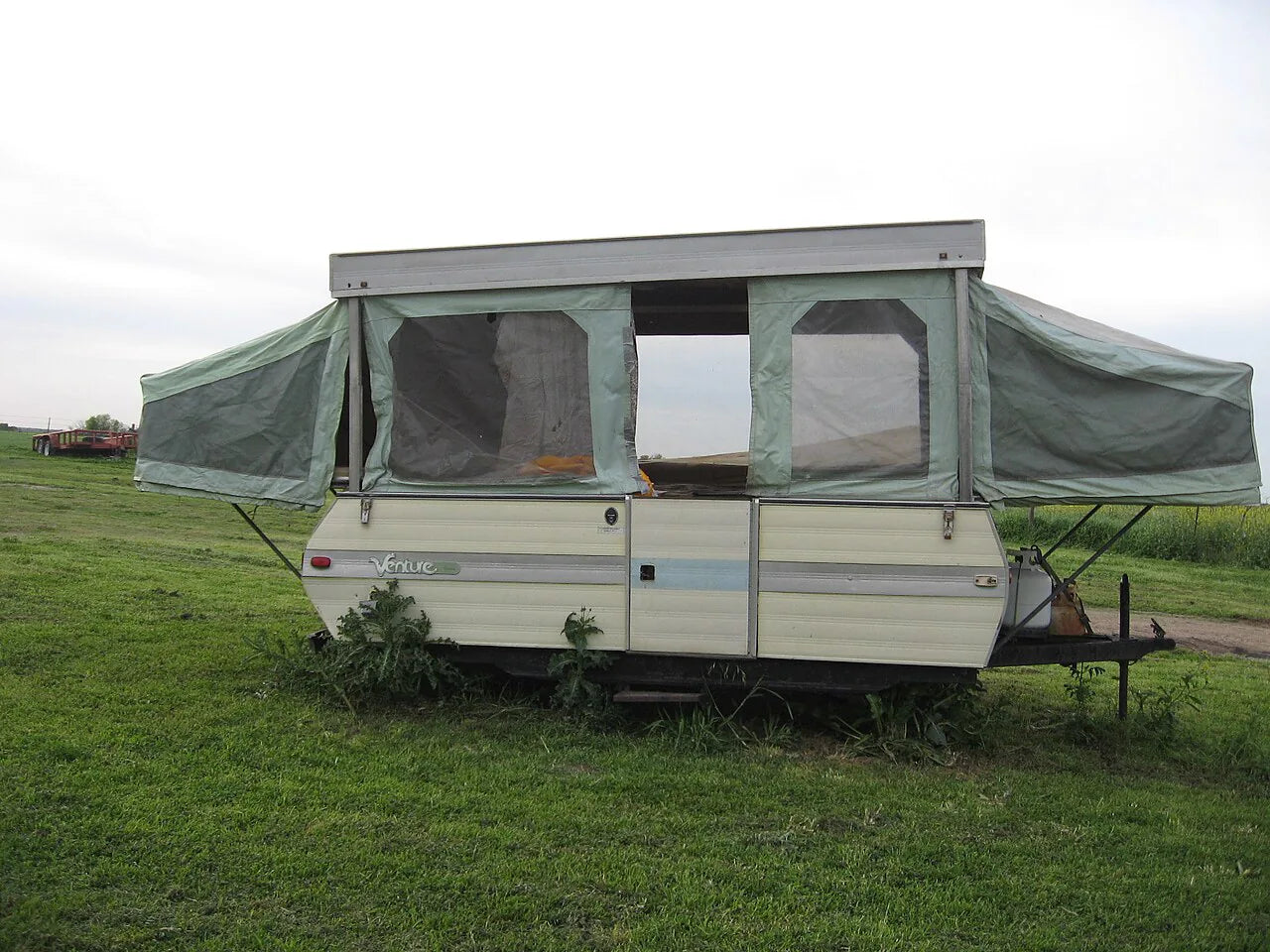 Popup camper opened at a campsite