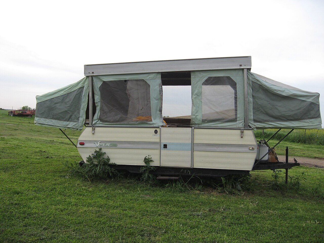 Popup camper opened at a campsite